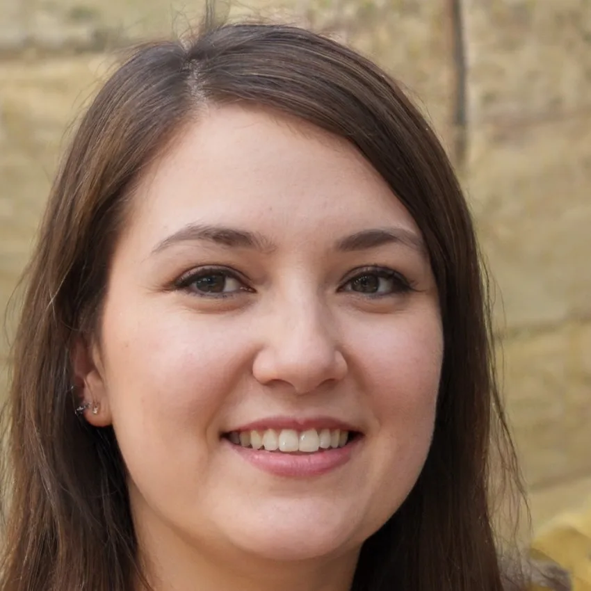 Smiling portrait of Emily Roberts, a young woman with straight brown hair, wearing casual attire, photographed in a sunny outdoor setting.